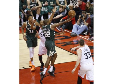 Milwaukee Bucks Khris Middleton SF (22) goes in for two points against Toronto Raptors Norman Powell SF (24) during the second half in Toronto, Ont. on Tuesday May 21, 2019. Jack Boland/Toronto Sun/Postmedia Network