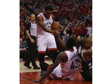 Toronto Raptors Kyle Lowry PG (7) helps teammate Pascal Siakim (43) off the court after he scored and was fouled during the second half in Toronto, Ont. on Tuesday May 21, 2019. Jack Boland/Toronto Sun/Postmedia Network