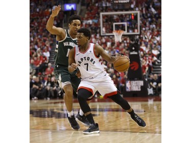 Toronto Raptors Kyle Lowry PG (7) cuts in on Milwaukee Bucks Malcolm Brogdon (13) during the second half in Toronto, Ont. on Tuesday May 21, 2019. Jack Boland/Toronto Sun/Postmedia Network