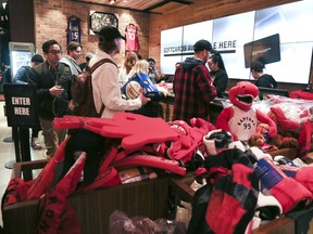 Raptors fans scoop up merchandise at the Real Sports Apparel located at the Scotiabank Arena on Thursday May 30, 2019. Veronica Henri/Toronto Sun