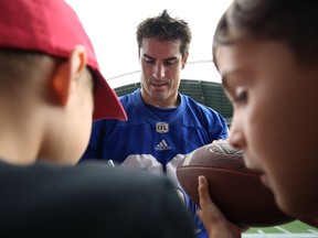 New Argos linebacker Ian Wild, here signing autographs for some children last year, brings speed, versatility and leadership to the Toronto defence. Kevin King/Postmedia Network