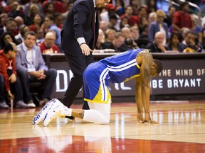 Warriors’ Andre Igoudala takes a little while to get up after a collision during Sunday night’s game. (STAN BEHAL/Toronto Sun)