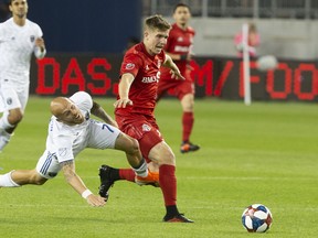 Toronto FC's Liam Fraser rides San Jose Earthquakes' Magnus Eriksson off the ball during their match last month. (THE CANADIAN PRESS)