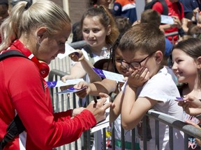 Canadian striker Adriana Leon signs an autograph following a training session at the Complexe Sportif de Laverune in Laverune, France on Thursday June 6, 2019. Canada open the FIFA 2019 Women's World Cup against Cameroon on Monday in Montpellier, France.