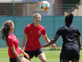Canadian defender Rebecca Quinn, centre, keeps her eye on the the ball as midfielder Julia Grosso, left, and Robyn Gayle, EXCEL mental and cultural manager, look on at a training session at the Complexe Sportif de Laverune in Laverune, France on Thursday June 6, 2019. Canada open the FIFA 2019 Women's World Cup against Cameroon on Monday in Montpellier, France.