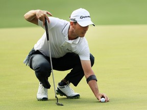 Mike Weir of Canada lines up a putt on the first green during the first round of the Masters at Augusta National Golf Club on April 11, 2019 in Augusta, Georgia.