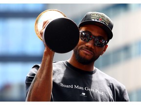 Kawhi Leonard #2 of the Toronto Raptors holds the MVP trophy during the Toronto Raptors Victory Parade on June 17, 2019 in Toronto, Canada. The Toronto Raptors beat the Golden State Warriors 4-2 to win the 2019 NBA Finals.