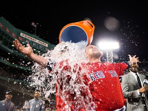 Christian Vazquez is doused in water by teammate Brock Holt of the Boston Red Sox after hitting a walk off home run in the tenth inning against the Toronto Blue Jays at Fenway Park on June 21, 2019 in Boston. (Kathryn Riley /Getty Images)