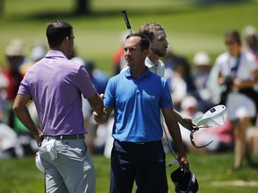 Nick Taylor of Canada shakes hands with  Mike Weir and David Hearn of Canada after their round in the first round of the RBC Canadian Open at Hamilton Golf and Country Club on Thursday. (Photo by Mark Blinch/Getty Images)