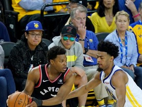 Golden State Warriors minority investor Mark Stevens (rear, blue shirt) watches Kyle Lowry look to pass against the Warriors during Game Three of the 2019 NBA Finals Wednesday night.