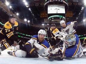 Carl Gunnarsson and Jordan Binnington  of the St. Louis Blues defend the goal against the Boston Bruins during the third period in Game Five of the 2019 NHL Stanley Cup Final at TD Garden on June 06, 2019 in Boston, Massachusetts.