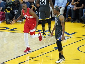 Raptors’ Serge Ibaka is pumped after hitting a shot in the second half of Game 4 on Friday while Andre Iguodala of the Warriors looks a little exasperated. Ibaka’s block-and- basket sequence in the third quarter was a complete demoralizer. 
 Thearon W. Henderson/Getty Images