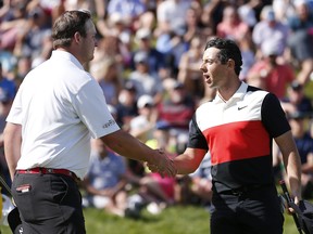 Rory McIlroy of Northern Ireland shakes hands with Sepp Straka of the United States after completing their third round of the RBC Canadian Open at Hamilton Golf and Country Club on June 08, 2019 in Hamilton, Canada. (Photo by Michael Reaves/Getty Images)