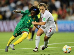 Gabrielle Aboudi Onguene of Cameroon battles for possession with Allysha Chapman of Canada during the 2019 FIFA Women's World Cup France group E match between Canada and Cameroon at Stade de la Mosson on June 10, 2019 in Montpellier, France.
