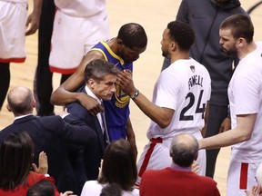 Kevin Durant #35 of the Golden State Warriors is assisted off the court after sustaining an injury in the first half against the Toronto Raptors during Game Five of the 2019 NBA Finals at Scotiabank Arena on June 10, 2019 in Toronto. (Photo by Claus Andersen/Getty Images)