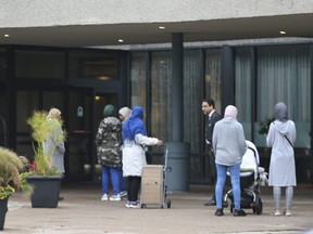 A group of women and there children are pictured outside the  Radisson hotel at Hwy. 401 and Victoria Park Ave. on Oct. 2, 2018. The hotel was housing refugees. (Jack Boland, Toronto Sun)
