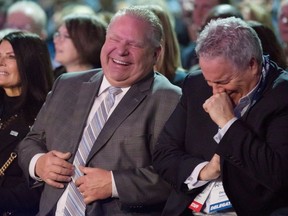 Ontario Premier Doug Ford, left, and then-chief of staff Dean French share a joke as they wait to hear federal Conservative Leader Andrew Scheer speak at the Ontario PC Convention in Toronto on Nov. 17, 2018.
