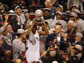 Toronto Raptors' Kawhi Leonard raises the Eastern Conference championship trophy after beating the Milwaukee Bucks. (JACK BOLAND/Toronto Sun)