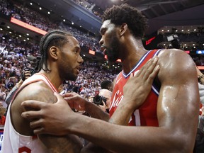 Toronto Raptors' Kawhi Leonard hugs Philadelphia 76ers' Joel Embiid after Game 7 of their series. (JACK BOLAND/Toronto Sun)