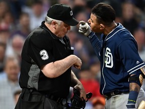 MLB home plate umpire Bill Welke, left, and San Diego Padres shortstop Manny Machado have words following his ejection during the fifth inning against the Colorado Rockies at Coors Field. (Ron Chenoy-USA TODAY Sports)