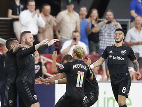 D.C. United forward Wayne Rooney (#9) celebrates with teammates after scoring a goal from beyond midfield against Orlando City SC this week. (USA TODAY SPORTS)
