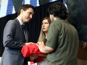 Prime Minister Justin Trudeau is presented with the final report during the closing ceremony of the National Inquiry into Missing and Murdered Indigenous Women and Girls in Gatineau, Quebec, Canada, on June 3, 2019. (REUTERS/Chris Wattie )