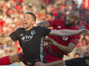 Sporting Kansas City defender Andreu Fontas, left, battles for a ball with Toronto FC forward Terrence Boyd (91) during the second half against Sporting Kansas City at BMO Field.Nick Turchiaro-USA TODAY Sports
