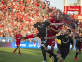 Sporting Kansas City defender Andreu Fontas (4) battles for a ball with Toronto FC forward Terrence Boyd (91) during the second half against Sporting Kansas City at BMO Field.Nick Turchiaro-USA TODAY Sports