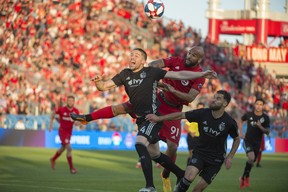 Sporting Kansas City defender Andreu Fontas (4) battles for a ball with Toronto FC forward Terrence Boyd (91) during the second half against Sporting Kansas City at BMO Field.Nick Turchiaro-USA TODAY Sports