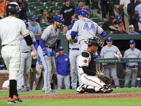 Toronto Blue Jays designated hitter Rowdy Tellez (44) celebrates with teammates after hitting a grand slam in the fifth inning against the Baltimore Orioles at Oriole Park at Camden Yards. Mitch Stringer-USA TODAY Sports