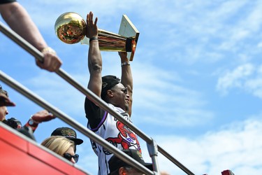 Toronto Raptors guard Kyle Lowry holds the Larry O'Brien trophy aloft during the Toronto Raptors Championship Parade on Lakeshore Boulevard. Gerry Angus-USA TODAY Sports