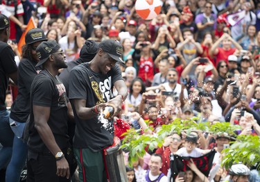 Raptors Pascal Siakam sprays the crowd while on the bus at the Toronto Raptors Championship Parade. Nick Turchiaro-USA TODAY Sports