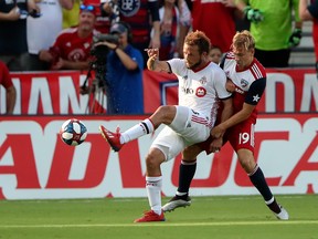 Toronto FC midfielder Nick DeLeon (18) controls the ball as FC Dallas midfielder Paxton Pomykal (19) defends during the first half at Toyota Stadium in Dallas on Saturday. Kevin Jairaj-USA TODAY Sports
