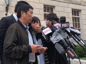 Ronggao Zhang, father of  Chinese graduate student Yingying Zhang, reads a statement on behalf of the family outside U.S. District Courthouse, after Brendt Christensen was found guilty of kidnapping and murder in the student's 2017 death, in Peoria, Illinois, U.S., June 24, 2019.