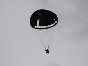 A paratrooper takes part in a parachute drop from seven C-47 aircraft over Carentan, Normandy, north-western France, on June 5, 2019, as part of D-Day commemorations marking the 75th anniversary of the World War II Allied landings in Normandy.