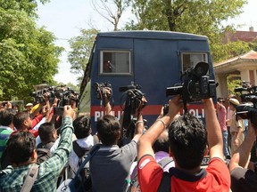 Media gather around a Punjab Police vehicle carrying the seven accused for the rape and murder of an eight-year-old nomadic girl in Kathua in Jammu and Kashmir, as verdict is expected to be delivered at the district court in Pathankot on June 10, 2019. NARINDER NANU/AFP/Getty Images