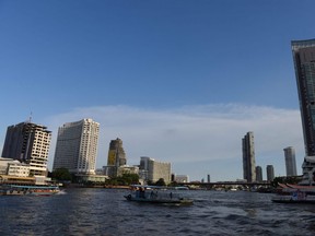 Ferries transport passengers across the Chao Phraya river in Bangkok on June 20, 2019. (TANG CHHIN Sothy/AFP)