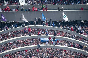 Fans climb the arches at Nathan Phillips Square ahead of the Toronto Raptors championship parade in Toronto, on Monday, June 17, 2019. THE CANADIAN PRESS/Andrew Lahodynskyj