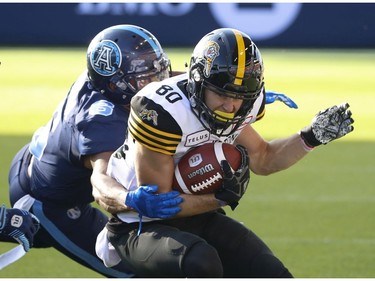 Hamilton Tiger Cats Jaelon Acklin WR (80) makes sideline catch against Toronto Argonauts Nakas Onyeka LB (6) during the fourth quarter in Toronto, Ont. on Saturday June 22, 2019. Jack Boland/Toronto Sun/Postmedia Network