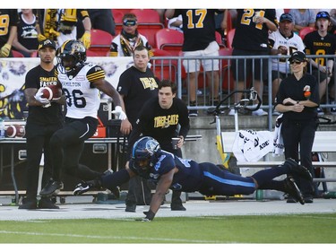 Hamilton Tiger Cats Bralon Addison WR (86) scrampers past a diving Toronto Argonauts Justin Herdman-Reed LB (45) for his third touchdown of the game during the fourth quarter in Toronto, Ont. on Saturday June 22, 2019. Jack Boland/Toronto Sun/Postmedia Network