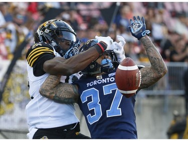Toronto Argonauts Anthony Covington DB (37) breaks up a touchdown pass to Hamilton Tiger Cats Josh Crockett WR (82) during the fourth quarter in Toronto, Ont. on Saturday June 22, 2019. Jack Boland/Toronto Sun/Postmedia Network