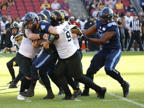 Argonauts quarterback McLeod Bethel-Thompson gets sacked by the Tiger-Cats.   Jack Boland/Toronto Sun