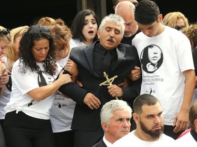 Pallbearers help Victor Navarro, holding cross, at the funeral of his daughter Ariela Navarro-Fenoy on Monday August 10, 2015. She was killed by random gunfire at the Muzik nightclub last week. (Michael Peake/Toronto Sun/Postmedia Network)
