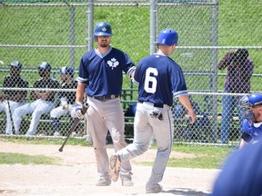 Leafs catcher Justin Marra (left) congratulates DH Dan Marra after scoring a run. (Max Lewis)