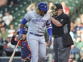 Houston, TX, USA; Toronto Blue Jays third baseman Vladimir Guerrero Jr. reacts after being hit by a pitch against the Houston Astros during the first inning at Minute Maid Park.