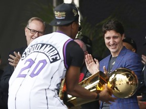 Raptors guard Kyle Lowry shows the Larry O'Brien championship trophy to Canadian prime minister Justin Trudeau during a rally at Toronto city hall Nathan Phillips Square.