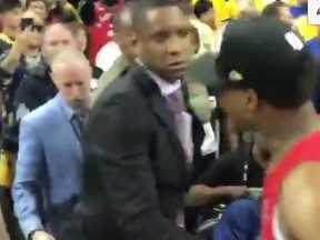 The Toronto Raptors Kyle Lowry is pictured pulling Raptors president Masai Ujiri on to the court in Oakland after an alleged assault against a police officer.