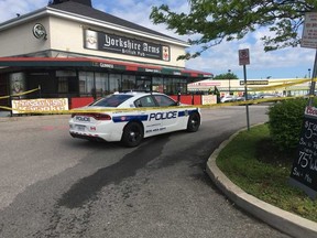 Peel Regional Police officers are investigating a shooting at a mall in Mississauga. A man was critically wounded in the shooting. (Joe Warmington, Toronto Sun)