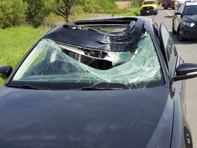 A vehicle is damaged on Hwy. 400 at Hwy. 89 after being hit by a bouncing wheel on Wednesday, June 12, 2019. (OPP_HSD/Twitter)
