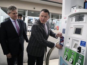 Greg Rickford, Minster of Energy, Northern Development and Mines, with an example of a sticker for gas pumps unveiled during a press conference on federal carbon taxes. (FILE/Postmedia Network)